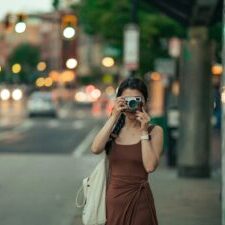Woman taking a picture with a vintage camera